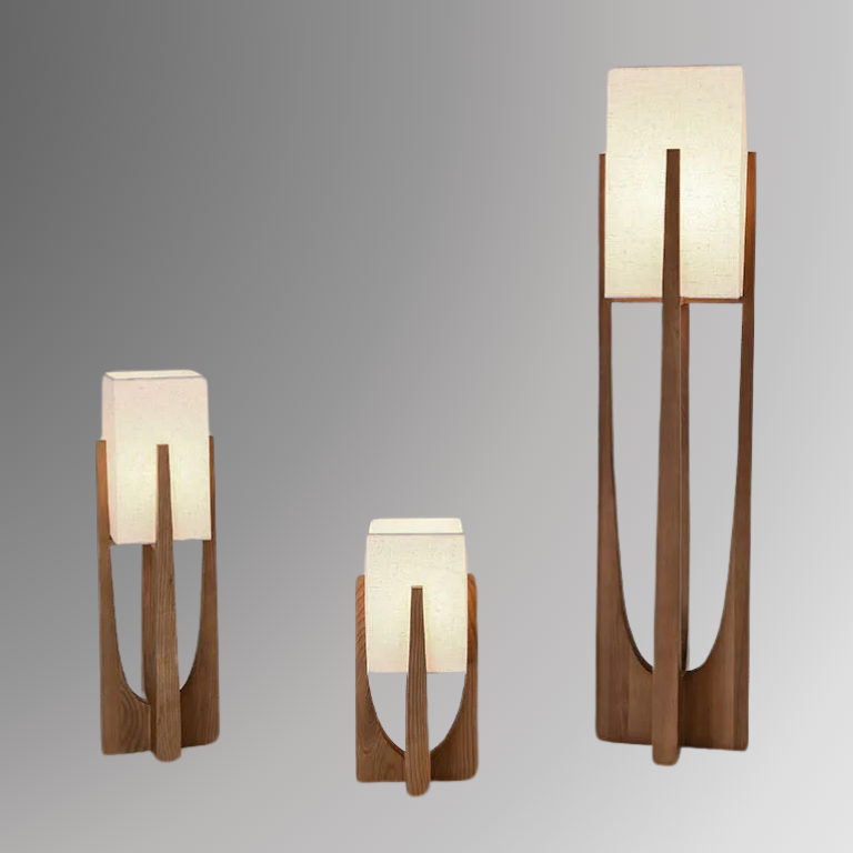Minari, a collection of lamps featuring forked wooden bases and cubed linen shades. The lamps are set against a greyscale background.