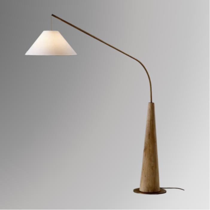 Ellis, a modern floor lamp with a light brown base and a tapered golden arm on a greyscale background.