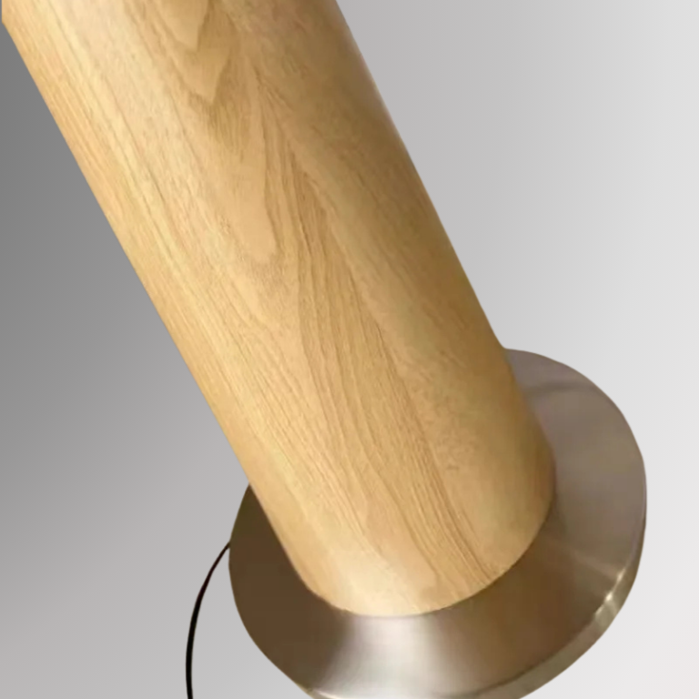 Close up showing Ellis' base details, featuring a wood grain design in light brown sitting on a gold plated iron base. All against a greyscale background.