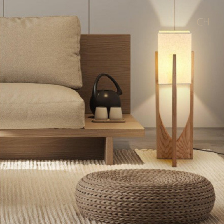 Minari, in its 32" height option, pictured in a room next to a wooden framed couch.