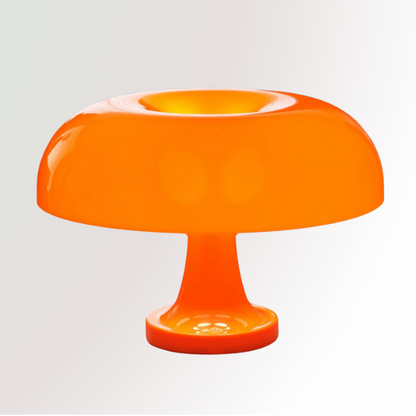 Giancarlo, a modern orange table lamp with a silhouette resembling a mushroom, pictured against a white pedestal.