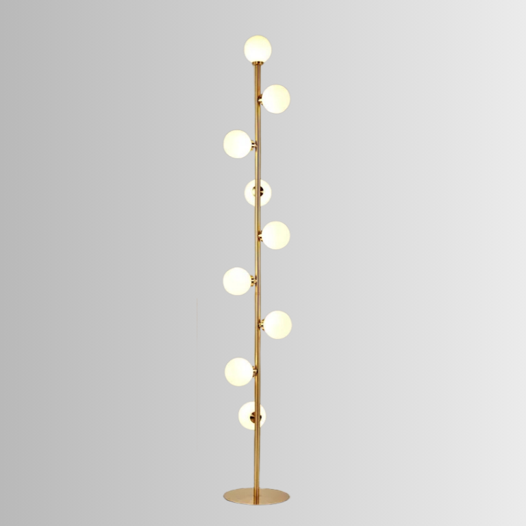 Atlas, a modern floor lamp, in brushed gold, with 9 circular bulbs on a grey background.
