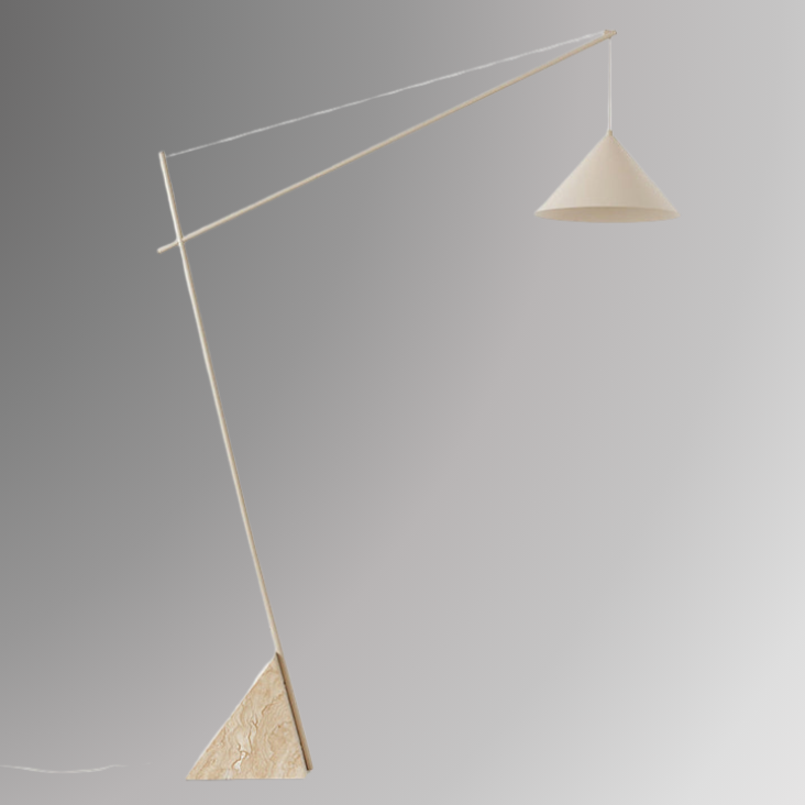 Quentin, a sculptural and minimalist floor light with a beige hued, geometric iron body, and a triangular marble base. Pictured against a greyscale background.