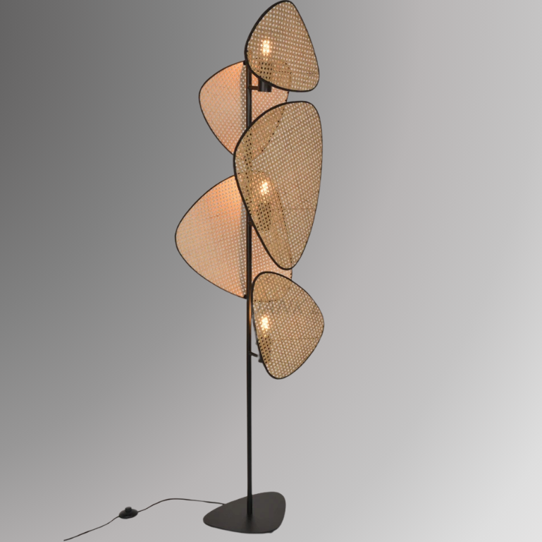 Saray, an iron based floor lamp with 3 light sources and 5 leaf shaped wicker shades, pictured against a greyscale background.