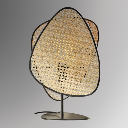 Saray, in 20" table option, featuring two leaf shaped wicker shades. Pictured against a greyscale background.