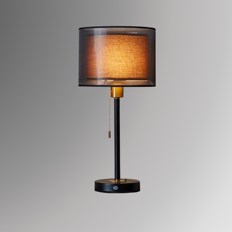 Ansel, a minimal table lamp with a dual shade design in brown, with a black neck. Ansel is photographed against a gray background