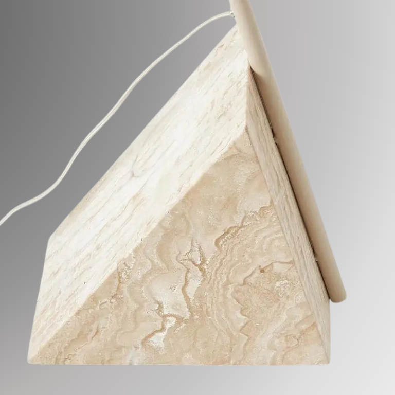 Detailed and zoomed shot of Quentin's triangular stone base. Pictured against a greyscale background.