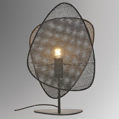 Saray, in 20" table option, featuring two leaf shaped wicker shades. Pictured in its black finish, against a greyscale background.